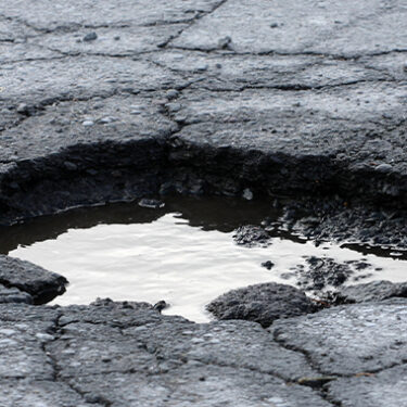 Gas Station Sued After Customer Trips in 1-Inch Pothole